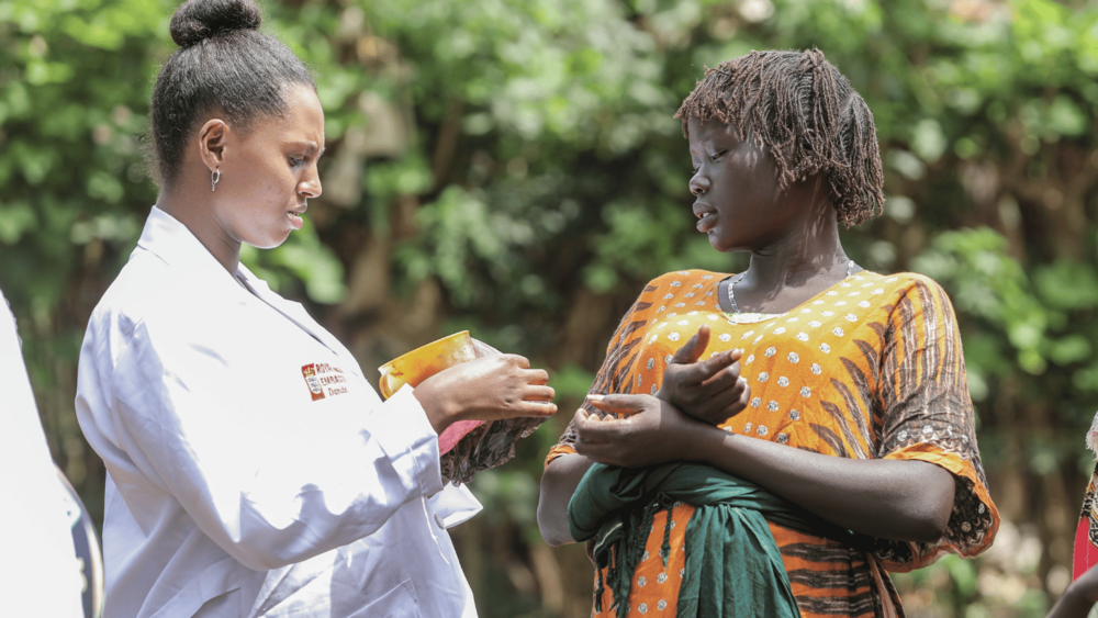 Abeba Bogale speaks gently with an expectant mother during a home visit—known affectionately as a sister in her community, she offers more than care; she offers comfort and trust.
