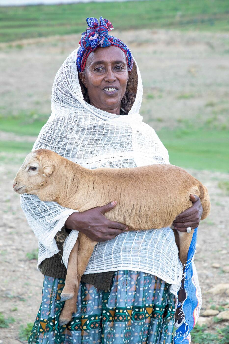 Yayesh, an Income-Generating Activity (IGA) participant, and her lamb.