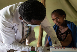 A UNFPA health extension worker providing health care services at a Mobile Health Unit in an IDP site in Amhara Region, Ethiopia