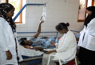A pregnant woman receiving attention from health professionals at a health center in Somali Region of Ethiopia