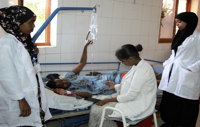 A pregnant woman receiving attention from health professionals at a health center in Somali Region of Ethiopia