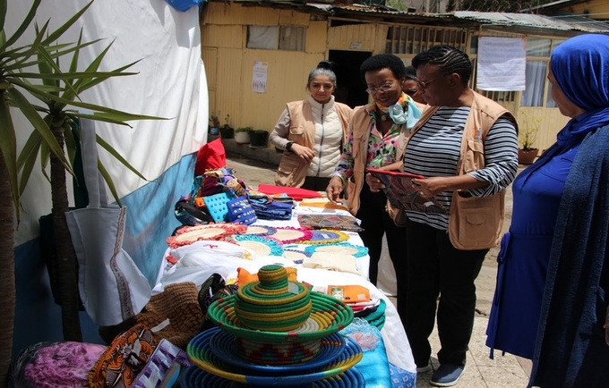 Ms. Zigomo observing some of the handcrafts made by survivors of GBV at the safe house.
