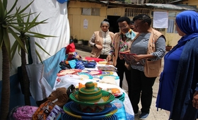 Ms. Zigomo observing some of the handcrafts made by survivors of GBV at the safe house.