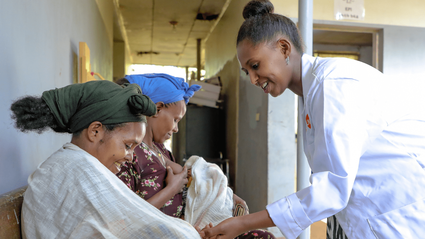Abeba Bogale connects with mothers outside Metti Health Center, offering reassurance, advice, and a listening ear, building trust one conversation at a time.