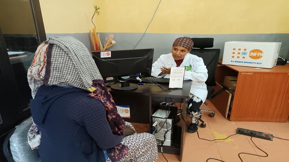 Almaz receiving counseling from a health professional at the one stop center