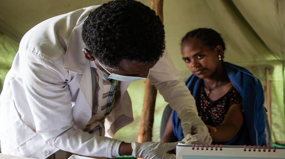 A UNFPA health extension worker providing health care services at a Mobile Health Unit in an IDP site in Amhara Region, Ethiopia