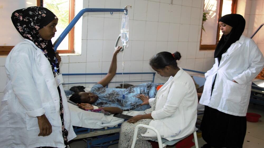 A pregnant woman receiving attention from health professionals at a health center in Somali Region of Ethiopia