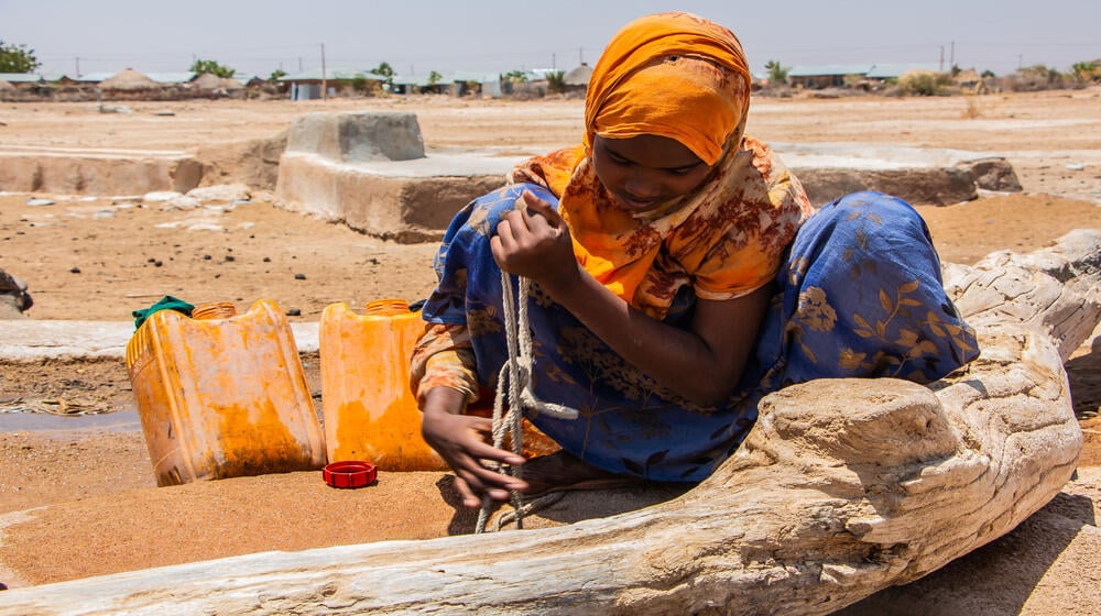 Deka Soane,13, dropped out school as she has to support her family fetching water to avoid any further animal loss. She walks mi