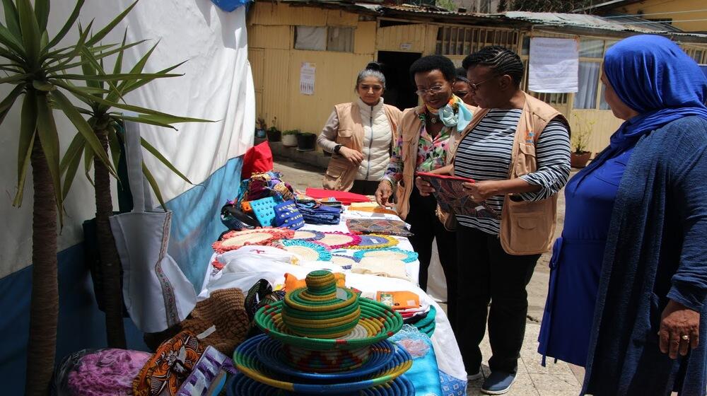 Ms. Zigomo observing some of the handcrafts made by survivors of GBV at the safe house.